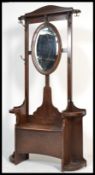 A 1920's oak hall settle umbrella / coat stand. The central hinged box seat with upright back having