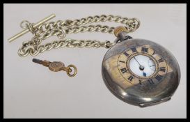 An early 20th century silver hallmarked London import pocket watch in a half hunter silver case. The
