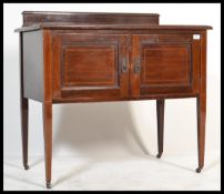 An Edwardian mahogany inlaid washstand cupboard raised on square tapering legs with twin door