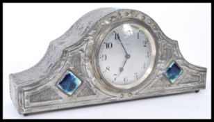 A Tudric pewter Art Nouveau mantle clock in the manner of Archibald Knox of Liberties. The clock
