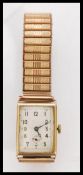 A vintage hallmarked 9ct gold square faced watch by Vertex with floral engraving to the case. The