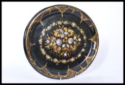 A 19th century Victorian papier mache tray depicting a central floral spray with gilded details