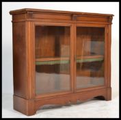 A 19th century Victorian mahogany library bookcase cabinet having shaped bracket feet and apron with