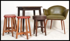 A mid century Benchair in original green vinyl together with a set of 4 vinyl topped bar stools with