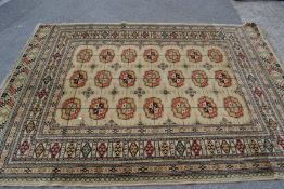 A mid 20th century floor carpet cream ground Persian Islamic rectangular rug having a central