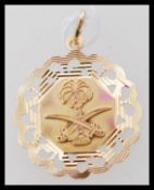 A high carat 22ct unmarked but gold testing Saudi Arabian necklace pendant featuring the  Saudi