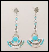 A pair of silver earrings inset with turquoise and marcasite's. The earrings are 6cm in length.