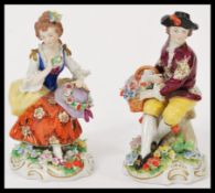 A pair of Sitzendorf porcelain figures of a gentleman holding a basket of flowers and a lady with