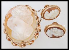 A 12ct gold carved shell cameo brooch along with a pair of 9ct gold screw back cameo earrings. Total