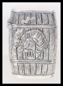 A contemporary silver plated Vesta case with embossed decoration in the form of a barrel featuring a