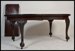 A 19th Century Victorian mahogany twin leaf extending dining table with two extra leaves, raised
