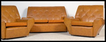 A vintage retro 20th century 1960's three piece suite of angular form consisting of two armchairs