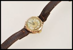 A hallmarked 9ct gold cocktail watch by Medana. The champagne dial having a mother of pearl