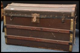 A 19th Victorian brown canvas and bound wooden steamer trunk chest with dome top. The trunk with