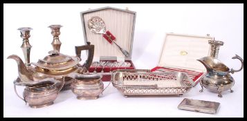 A collection of vintage silver plate to include candlesticks, part tea service, card / cigarette