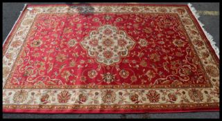 A large Iranian / Persian Keshan carpet - rug having red and beige ground with geometric medallion