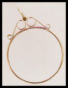 A 9ct clasp for a gold coin - Krugerrand etc. The circular clasp with scrolled top and with bale.