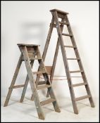 2 vintage 20th century Industrial wooden ladders. Each of A-frame form, one small and one large,