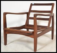 A vintage retro 20th century teak lounge chair of danish influence having a wooden frame. Measures