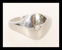A gents 9ct white gold and diamond signet ring. Hallmarked to the inner shank with single stone