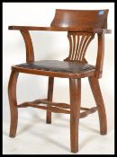 A 1920's oak Industrial Captains office desk chair. Raised on cabriole legs united by stretchers