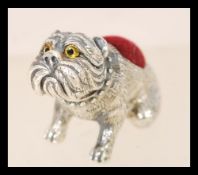 A contemporary sterling silver pincushion in the form of a bulldog in the style of Aide Lovkin.
