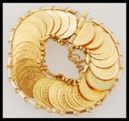 A high carat / 22ct gold Saudi Arabian coin bracelet set with 27 22ct gold testing replica coins