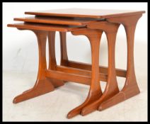 G-Plan - A set of three retro 20th Century teak wood tiled top nest of graduating tables raised on