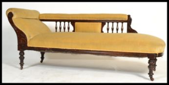 A Victorian mahogany chaise longue day bed raised on ring turned legs with castors. Above, an