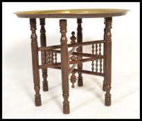 A vintage 20th century metamorphic folding Binaris occasional table having a collapsible wooden base