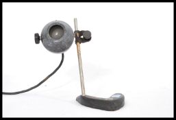 A vintage 20th century Scientific laboratory microscope light lamp raised on a V shapedcast metal