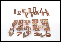 A collection of 19th century cast iron Roman Numerals and Arabic numbers with studded backs.