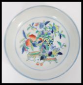 A 19th century Chinese blue and white hand painted plate having a central still life with peaches.