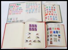 A group of four vintage stamp albums containing GB stamps dating from the 19th century including
