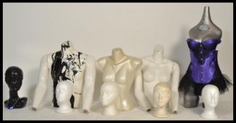 A collection of vintage male and female torso mannequins including five polystyrene head mannequins,