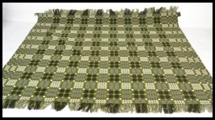 A  good mid century Welsh blanket having a green ground colour and geometric patterns  / decoration.