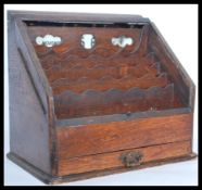 An early 20th century Edwardian oak desk calendar and stationary tidy compendium having fully