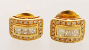 A pair of 18ct gold diamond earrings in the Art Deco style/ The item weighs 4.5 grams.