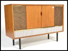 A vintage retro 20th century teak radiogram raised on ebonised supports with grille front. Twin