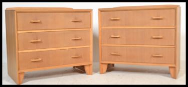 A pair of vintage retro 20th Century matching chest of drawers, in light oak having a run of three