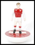 A Royal Doulton Subbuteo ceramic football figurine MCL 12 featuring a player in red and white kit on