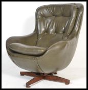 A 1970's retro swivel egg chair - armchair being raised on a teak 4 prong swivel base, the chair