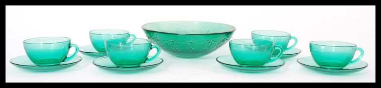 A set of six vintage 20th century French glass cups and saucers by Arcoroc all in green. Makers