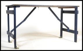 A vintage 20th Century ex=military planked dispersal table, planked top with metamorphic fold out