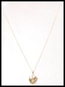 A hallmarked 9ct gold heart padlock pendant set to a fine 9ct gold necklace chain. Weighs 2.9