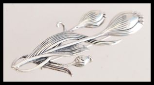 A contemporary silver Art Deco style flower brooch with a classic pin mechanism. The brooch is 6cm