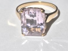 A hallmarked 9ct gold and amethyst dress ring.The amethyst being step cut and prong set within a