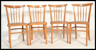 A set of four vintage retro 20th century wooden dining kitchen utility chairs raised on tapered