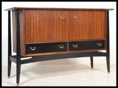 A 1960's/ mid century G-Plan Librenza pattern teak wood sideboard raised on an ebonised plinth