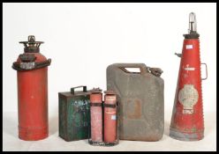 A group of vintage petrol cans and fire extinguishers to include a green enamel Castrol example.